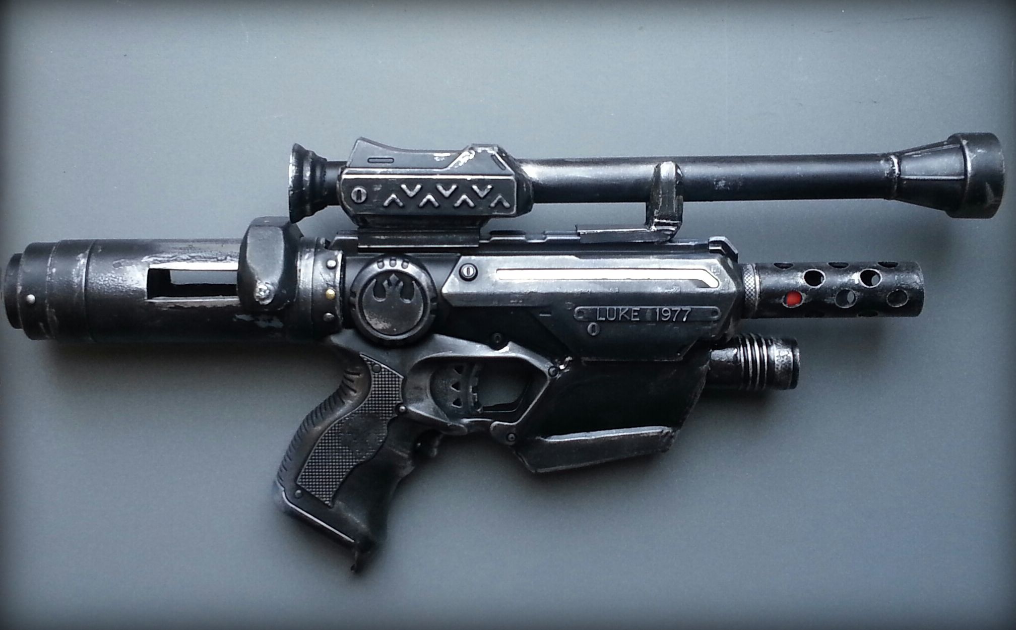 Modded Nerf blaster with the shell open on a workbench mid-upgrade