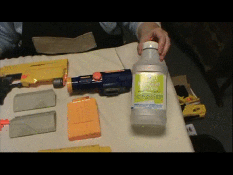 Scrubbing sanding dust off a Nerf blaster shell with a sponge