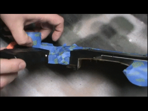 Pulling painter's tape away from a freshly painted Nerf blaster