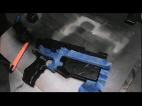 Laying a tape boundary line on a Nerf blaster before the accent coat
