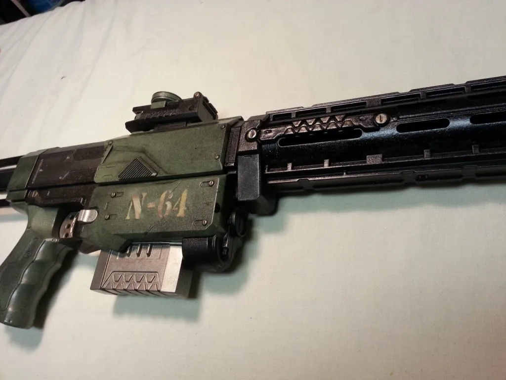 A Nerf blaster wearing a hand painted matte green field finish, with the clear coat still intact